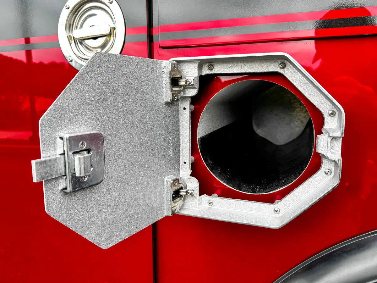 Second open fill-port door close-up showing intake opening and latch.